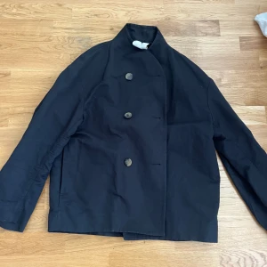 Arket kort kappa - Dubbelknäppt jacka i en blandning av linne och bomull. Perfekt tunn för vår och sommar. Fint skick! Köpt för 1590kr