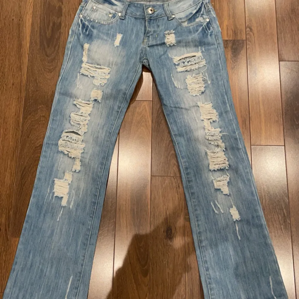 Så coola jeans med hål! Ljusblå med ljusare detaljer bak&fram. Lågmidjade! Pris kan diskuteras❤️ Innerbenslängd: 70cm  Midja tvärsöver: 35cm. Jeans & Byxor.