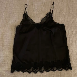 Sidenlinne spets svart - Svart sidenlinne med spets. Justerbara band. Inga anmärkningar, kommer bara inte till användning 💕✨