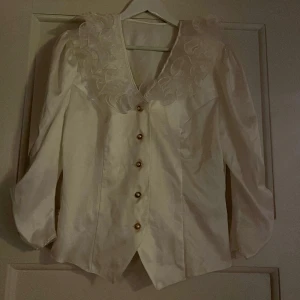 Blus  - En favorit blus med guld detaljer och puffiga ärmar! 