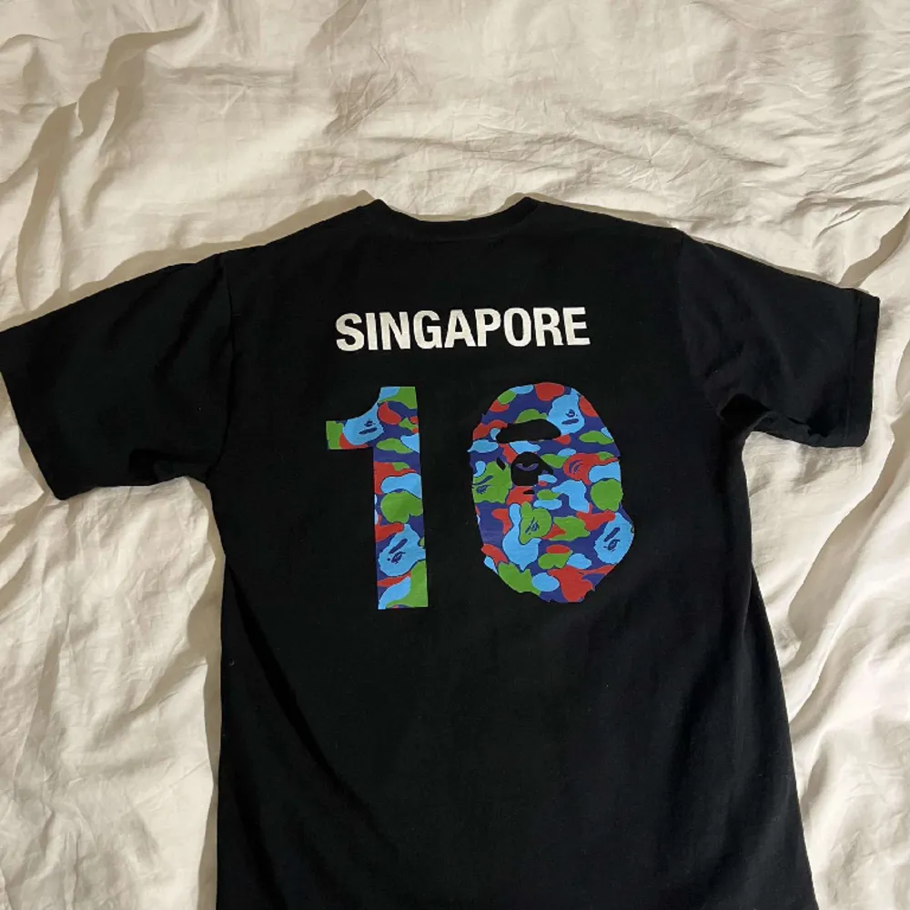 Rare piece only released during the Singapore drop . T-shirts.