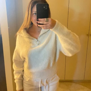 Stickad tröja - Vit stickad tröja med en dragkedje krage 