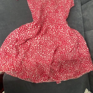 Linne klänning - En jätte fin, mjuk och söt klänning i linne material den är röd med vita prickar den är passar dig som är (34,36,38) i storlek