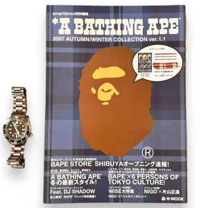Bape Magasin Bok - BAPE Magazine Book from 2007  72 pages of crazy lookbook collections showing products from the season, full sticker pack. Watchfor reference on how big the book is. Super cool accessory for anyone that loves Bape. These are a very interesting read!  