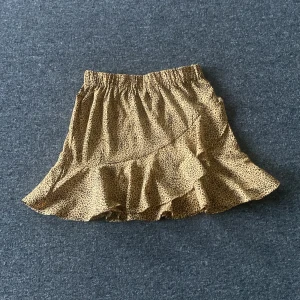  Leopard kjol - 34 cm och är högmidja