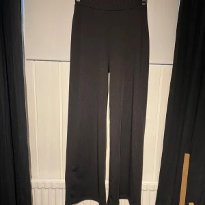 Byxor - Svarta ribbade byxor med vida ben, endast använda ett fåtal gånger. Enligt lappen är byxorna i storlek XS men jag skulle säga att som passar S/M också 