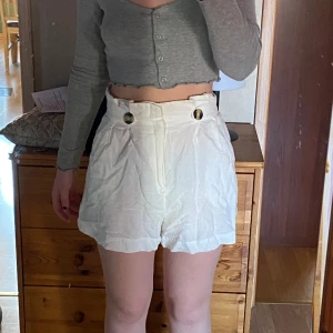 Linneshorts  - Vita linneshorts med knapp. Sitter som en smäck i midjan för mig som oftast har 36/38. Fläck och felfri men säljer för att jag har andra. 
