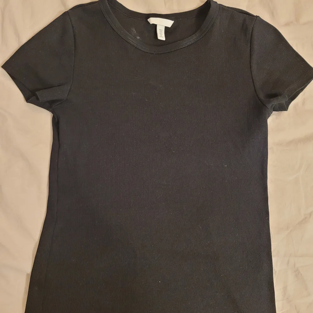 Säljer en svart T-shirt från H&M i storlek M. Har enbart använt ett fåtal gånger så den är i bra skick!💘. T-shirts.