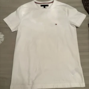 Tommy hilfigur t-shirt. Ny utan prislapp  - Vit Tommy hilfigur t-shirt storlek S men passar även XS. Ny men utan prislapp. Oanvänd. Fick den som present.