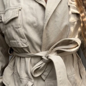 Beige overshirt med bälte och fickor - Storlek 36 men jag skulle säga att den passar bättre för någon som är 38/40 i storlek. Jah själv när vanligtvis medium  