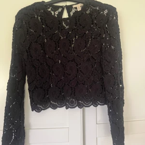 Svart spetsblus från H&M XS - Fin svart blus från hm med spets mönster, använd få gånger. Storlek xs 💕