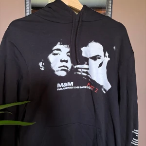 Svart hoodie med tryck från M&M - Säljer min M&M hoddie från deras hemsida. Den är använd 2 gånger och är i bra skick. Den är i st s och säljer den för 300+frakt. (orginal pris  700kr) 