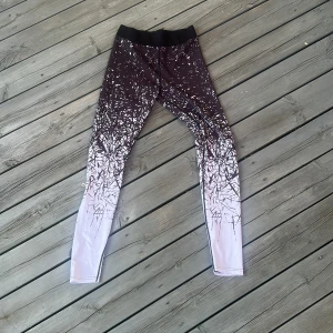 Svarta och vita leggings med mönster - Säljer ett par snygga leggings med svart och vitt abstrakt mönster som går från mörkt upptill till ljusare nedtill. Har satt S som storlek men skulle säga att de går mellan S-M .De har en bred midjeresår och är perfekta för träning eller chill. Materialet är stretchigt och följsamt för maximal komfort.