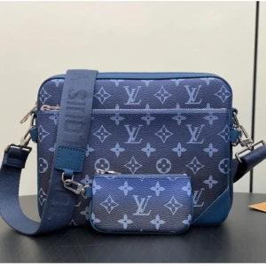 Blå axelväska Louis Vuitton monogram - Snygg blå axelväska från Louis Vuitton med klassiskt monogrammönster i ljusblått. Väskan har bred justerbar axelrem, silverfärgade metalldetaljer och en avtagbar liten pouch framtill. Tillverkad i skinn med präglad logga och dragkedja upptill.
