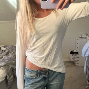 Vit långärmad topp från Lindex - Säljer en enkel och stilren vit långärmad topp från Lindex. Tröjan har rund halsringning och är tillverkad i mjuk bomull, perfekt till jeans eller kjol. Passformen är normal och materialet känns lätt och bekvämt.