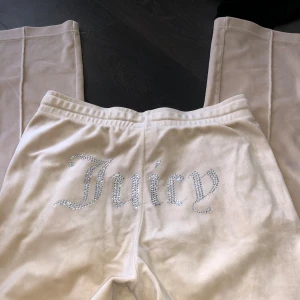 Beige mjukisbyxor från Juicy Couture - Säljer ett par beige mjukisbyxor från Juicy Couture med glittrande text på baksidan. Knappt använda. Dom är hödmidjade 🥰