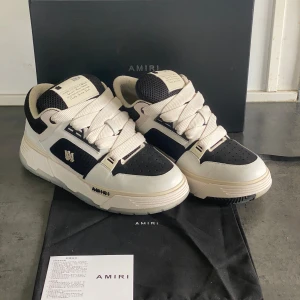 Amiri MA-1 - Snygga Amiri sneakers i svart och vitt med chunky sula och breda snören. Skorna har meshpaneler, detaljer i skinn och Amiri-logga på sidan. Perfekt för dig som gillar streetstyle och vill sticka ut med exklusiva detaljer. Andvända 2 gånger😃