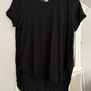 Svart t-shirt från Wera Stockholm - Säljer en stilren svart t-shirt från Wera Stockholm. Den har en klassisk design med korta ärmar och rund halsringning. Perfekt för en enkel och snygg look.