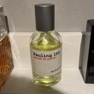 Pauling 19.0 extrait de parfum - Pauling 19.0 extrait de parfum från one hold chem. Flaskan är rund i genomskinligt glas med silverfärgad kork och en enkel vit etikett med svart och röd text. Parfymen har en ljusgul vätska och modern design. 50ml.