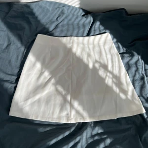 Vit kortkjol  - En helt oanvänd, vit kortkjol från Cider i storlek M. Köptes via Sellpy och säljs då den är för liten för mig. Midjemåttet är 74 (enligt Sellpy) och skulle säga att den passar S också. Den har innertyg, liten slits och dragkedja bak (se bilder). Skriv gärna vid frågor🤗