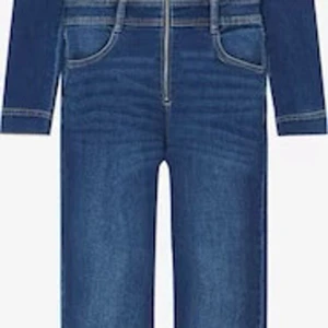 Jeans jumpsuit från Pull&Bear - Snygg jeans jumpsuit från Pull&Bear med dragkedja framtill och klassisk krage. Den har långa ärmar och fickor på bröstet med knappar.  Aldrig använd, i storlek s