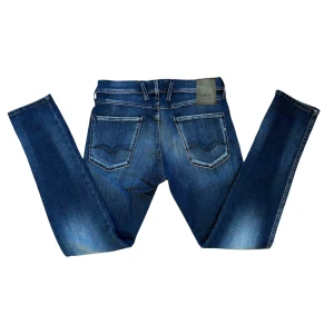 Blå Replay Jeans - Snygga blå jeans från Replay i modellen Anbass. De har en klassisk femficksdesign med en knappgylf. Jeansen är tillverkade i ett stretchigt material för extra komfort och har en lätt tvättad look. Dem är i modellen Anbass Hyperflex och är i super bra skick‼️Kom gärna med frågor eller prisförslag😇 Först till kvarn‼️