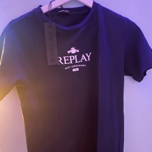 Mörkblå t-shirt från Replay (helt ny) - Snygg mörkblå t-shirt från Replay med tryck på bröstet. Perfekt för en casual look. Gjord i mjukt material för extra komfort. OBS Aldrig använd
