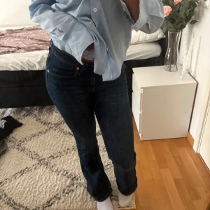 Blå bootcut jeans - Mörkblåa bootcut jeans från Lager 157 i modellen Low Boot, dessa är aningen kortare i benlängd (jag är ca 165 cm ). Jeansen har låg midja och är tillverkade i stretchig bomullsdenim för en bekväm passform. De har använts ett antal gånger, men de är fortfarande i fint skick och hela! 