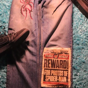 Spiderman Jeans - These are custom made, only 1 of 1 in the world. I make stuff like this all the time so shoot me a DM if you have a design in mind and want some jeans to be made out of it. The waist on these are 31 inches and the length is 34 inches. 