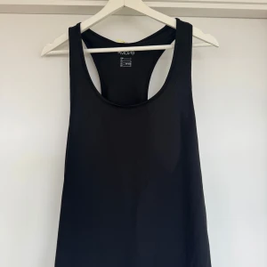 Svart träningslinne från H&M Move - Säljer ett svart träningslinne från H&M Move. Perfekt för träning med sin bekväma passform och ärmlösa design. Tillverkad i ett mjukt och stretchigt material som andas bra. Passar utmärkt för aktiva dagar.