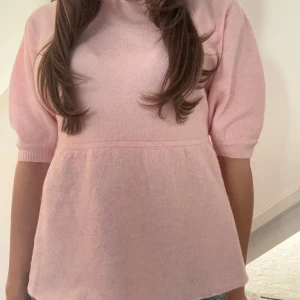 Rosa tröja med puffärmar - Söt rosa tröja med puffiga kortärmar och en lös passform. Perfekt för en avslappnad stil. Den har en rund hals och är gjord i ett mjukt material. Helt ny med lapp och aldrig använd. Pris kan diskuteras 