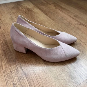 Snygga och fina ljusrosa mocka pumps/klackar från Vagabond - Säljer ett par ljusrosa pumps från Vagabond i mjuk mocka. Skorna har en bred klack och spetsig tå, vilket ger en stilren och modern look. Perfekta för dig som vill ha både komfort och stil.