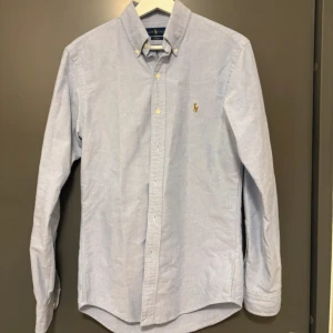 Blå skjorta från Ralph Lauren - Klassisk ljusblå skjorta från Ralph Lauren i slim fit nyskick 