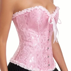 Rosa korsett med spets och snörning - Supersöt rosa korsett med glansigt blommönster, vita volangkanter och rosett framtill. Snörning i ryggen för perfekt passform och metallknappar framtill. Perfekt för dig som vill sticka ut med en romantisk och feminin vibe.