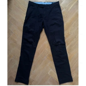 Marinblå chinos från Polo Ralph Lauren - Knappt använda marinblåa chinos från Polo Ralph Lauren med klassisk passform. Byxorna har bälteshällor, knäppning fram och bakfickor med knapp. Perfekta för ⛳️🏌🏼. 