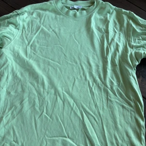 Mintgrön t-shirt från Zara - Fräsch mintgrön t-shirt från Zara i klassisk modell med rund hals och korta ärmar. Tillverkad i mjuk bomull som känns skön mot huden. Perfekt för dig som gillar stilrena och enkla plagg med en poppig färg.
