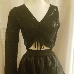 Top med paljetter - Vintage Jättesnygg top översållad av paljetter.  Långa ärmar med cutouts hela vägen. Köpt i London för flera år sen.  Använd ett par gånger. I skick som ny. Storlek M  Storlek M  Kjolen på bilden är också till salu