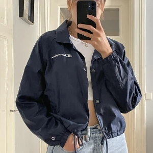 Champion Cropped windbreaker jacket - Skitcool, inte oversized, svinbra på våren. Råkade spilla nagellack på den på ryggen så har en liten fläck där men går förmodligen bort!