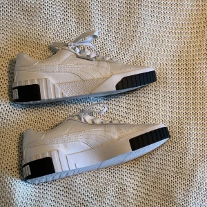 Vita sneakers  - Vita puma sneakers i storlek 39, knappt använda. Platt sula, vita skosnören! 