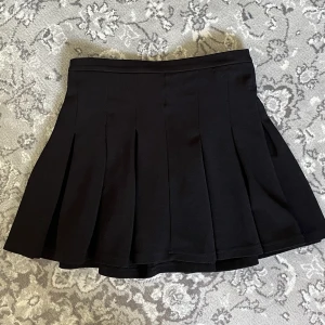 Svart minikjol - Svart kjol i bra skick! Har knappt använts då den är fel storlek för mej. (Köparen står för frakt men om du använder ”köp nu” - funktionen är frakten gratis)
