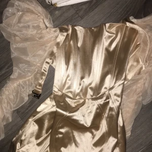 Champagne satin corset dress - Super soft, great quality, a size too big for me so it’s not really my style (brand is Club L London but it’s bought from ASOS)
