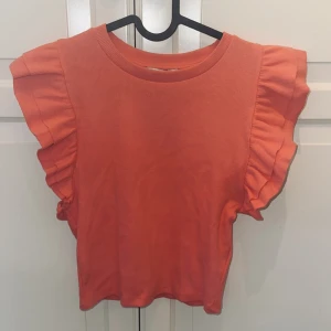 Topp med volanger  - En volangtopp från Zara i en jättefin aprikosrosa färg! Toppen är i storlek M men liten i storlek och säljer då den inte kommit till användning 💕Säljer för 50kr+ frakt🤍