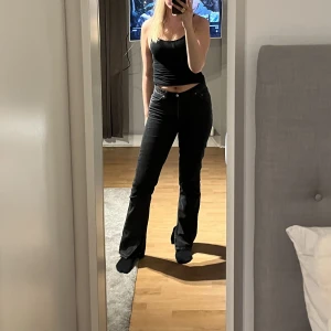 Svart jeans - Svarta jeans från asos med slits längst ner, mid waist. Sparsamt använda i bra skick! Storleken är i waist/length: 28/34🩷