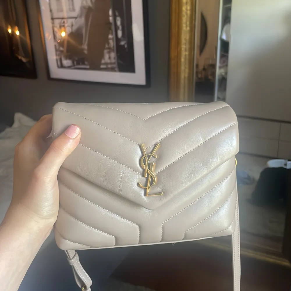 intressekoll på min fina beiga saint Laurent väska med beigt skinn och guld detaljer🥰NYSKICK, inte en enda defekt. Kvitto och dustbag tillkommer. Ord pris 17000kr. Väskor.