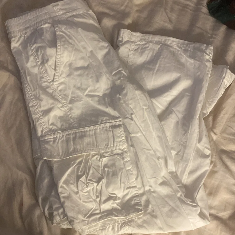 Säljer mina oanvända populära vita cargobyxor från HM då det inte är min stil längre.. Jeans & Byxor.