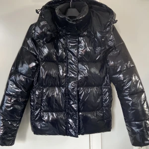 Calvin Klein Vinterjacka - Calvin Klein High Shine Puffer i Nyskick🖤Nypris 2195kr på Zalando. OBS: Den är liten i storleken. Skulle säga att den motsvarar en S. Är 165cm och den sitter lagom på mig. 