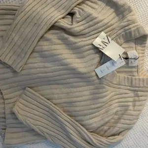 En jättefin oanvänd beige stickad tröja från Zara. Prislappen är kvar. Original pris:265kr. Passar säkert nån storlek större💗💗