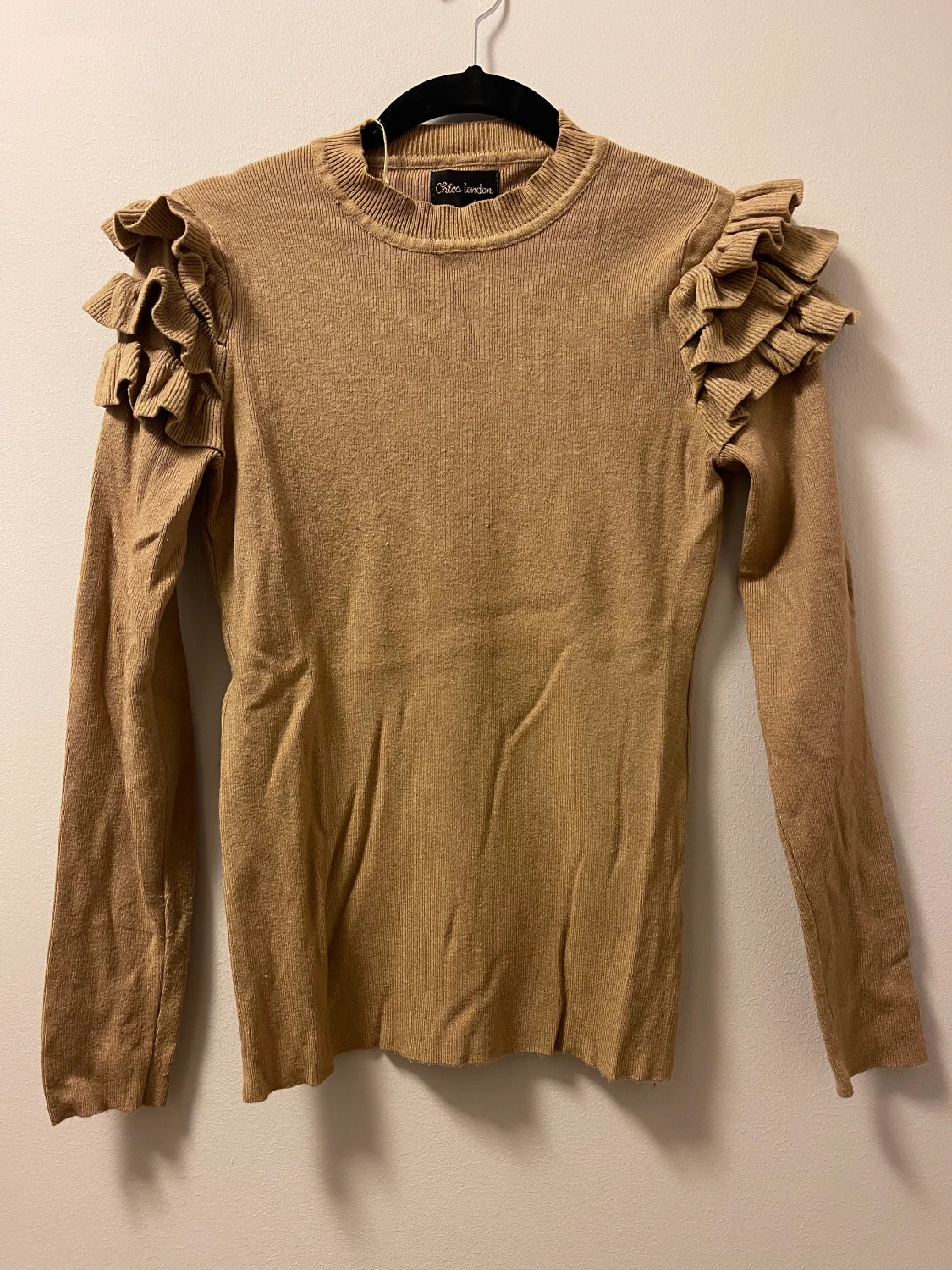 Stickad tröja med volang