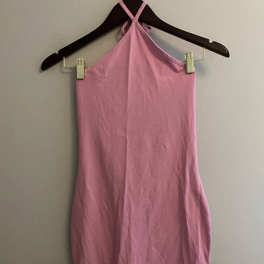 Kort rosa halterneck klänning. Aldrig använd och med prislappen kvar. . Klänningar.