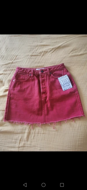 Snygg jeanskjol från populära märket Free people - Aldrig använd pga för liten för mig. Snyggt med ett par svarta cykelbyxor under. 26 inch midjan. 